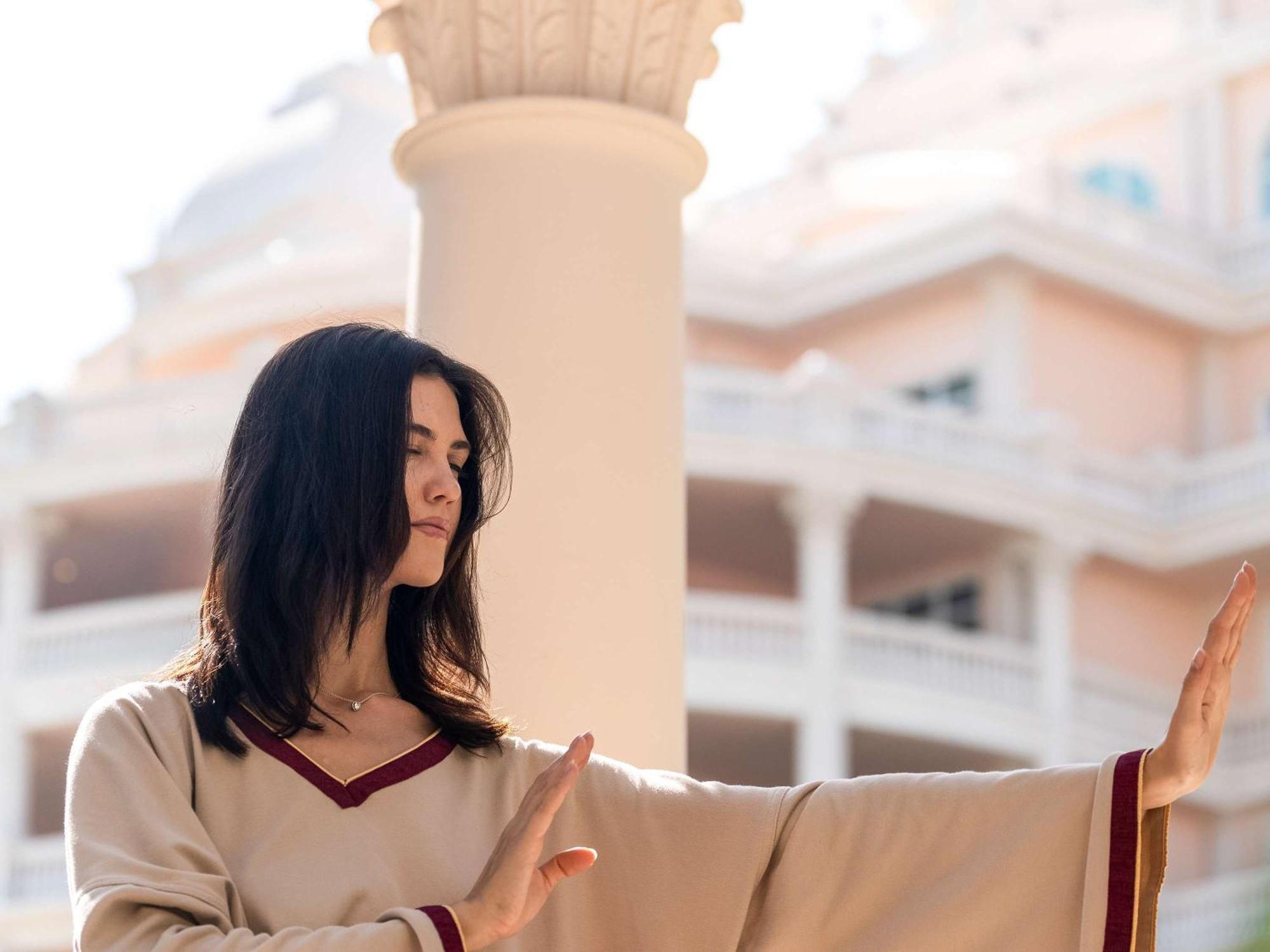Raffles The Palm Hotel Dubai Exterior photo A woman meditating